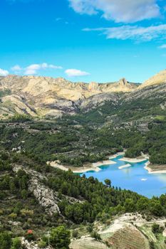 The swamp of Guadalest village surrounded by vegetation and mountains on a sunny day