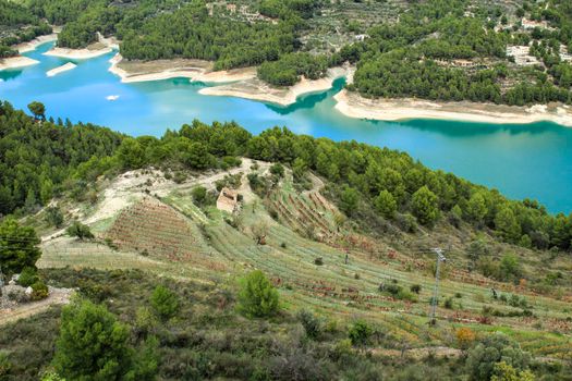 The swamp of Guadalest village surrounded by vegetation and mountains on a sunny day