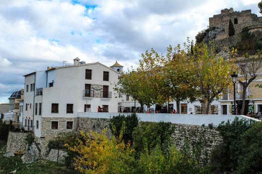 Beautiful view of Guadalest village surrounded by vegetation, mountains and the walls of the Castle