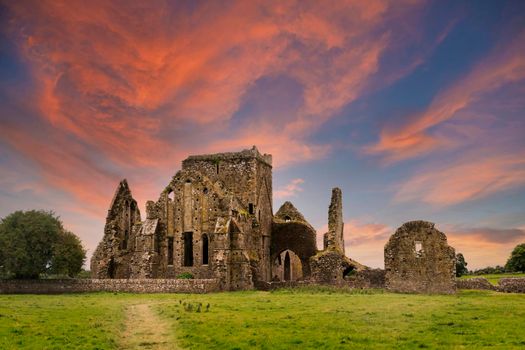 Ruins of Hore Abbey at sunset with reddish clouds, near the Irish village of Cashel. Built by Benedictine monks in the 13th century.