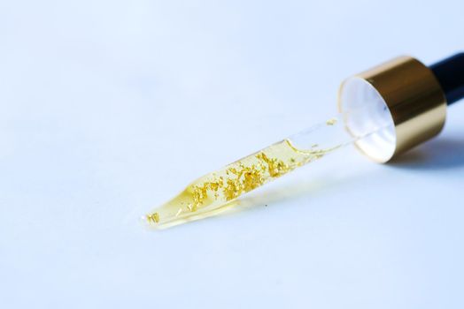Drop falls from a pipette into a cosmetic bottle,