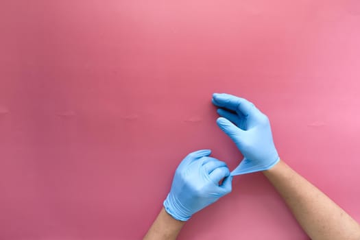 Doctor hand with glove on wooden background