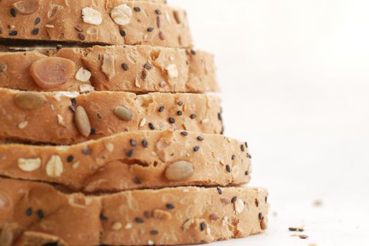 detail shot of whole grain baked bread on table .