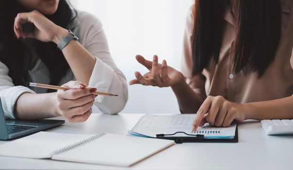 Close up business people analyzing investment graph meeting brainstorming and discussing plan in meeting room, investment concept.