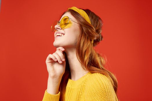 cheerful woman in yellow glasses fashion jewelry hippie. High quality photo