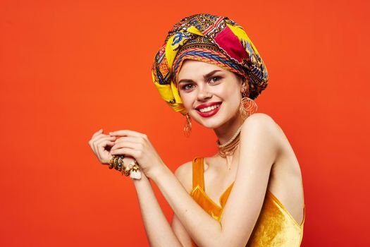 cheerful woman in multicolored turban attractive look Jewelry isolated background. High quality photo