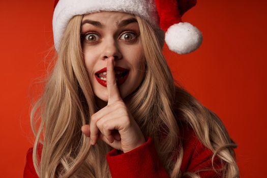 woman wearing santa hat christmas holiday red background. High quality photo