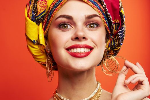 beautiful woman multicolored shawl ethnicity african style red background. High quality photo