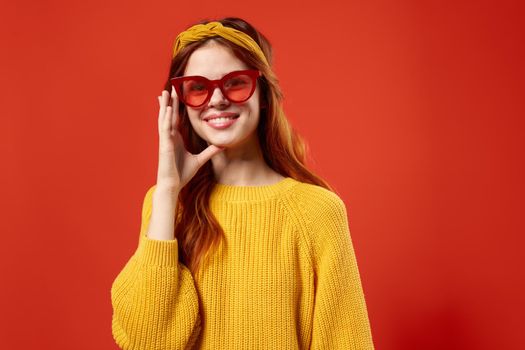 woman with yellow headband red glasses fashion yellow sweater. High quality photo