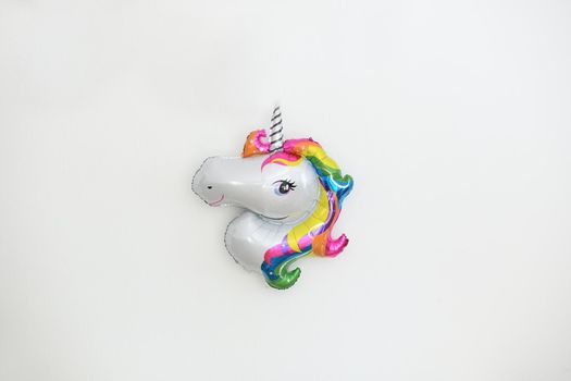 A inflatable unicorn hanging on the wall for birthday decoration