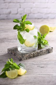 Refreshing summer alcoholic cocktail mojito with ice, fresh mint and lime