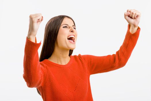 Beautiful and happy woman with arms up, isolated over white background 