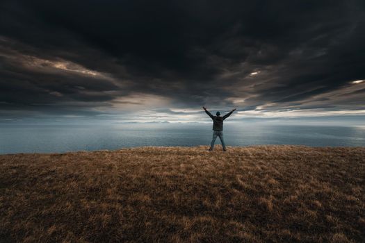 Man with arms raised enjoying the nature in Iceland9