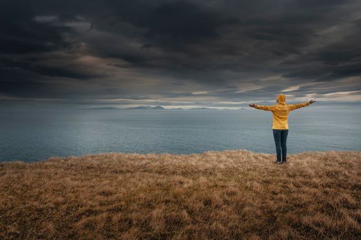 Woman with arms raised enjoying the nature in Iceland