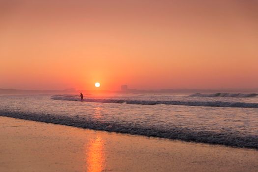 Surfing the waves at the sunset