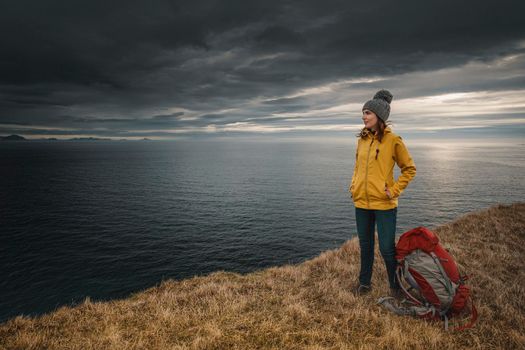 Female backpacker traveller in Iceland watching the Ocean