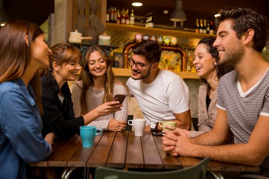 A group of friends talking and drinking coffee at the cafe