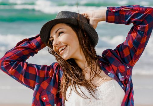 Beautiful and happy teen at the beach enjoying the summer