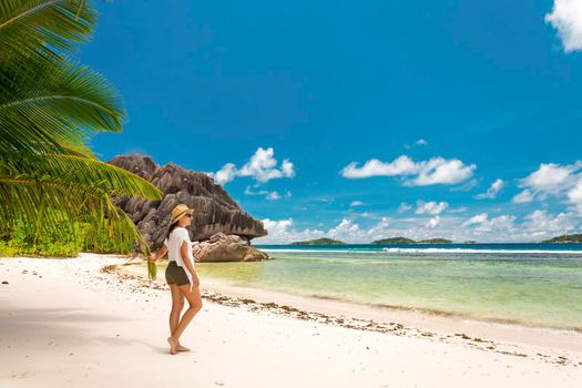 Beautiful woman enjoying the beach in La Digue, Seychelles
