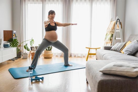 Pregnant woman doing exercises at home