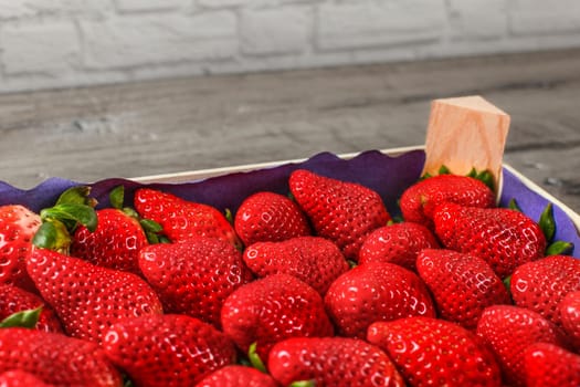 Closeup photo - box of strawberries from supermarket.