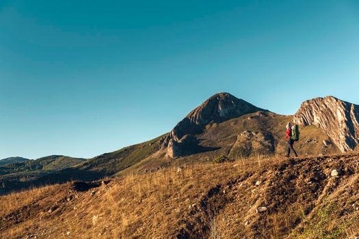 Shot of a woman exploring the montains with a backpack