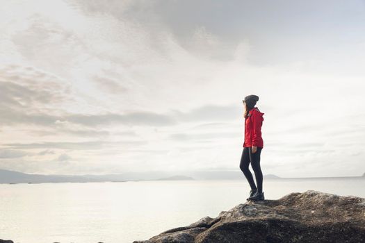 Woman enjoying the morning view of the coast