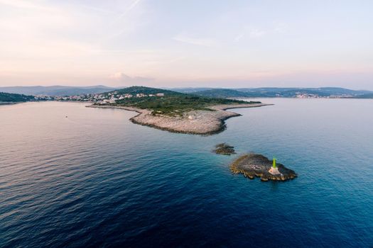 Lighthouse on an island opposite Punta Planca cape. Aerial view. High quality photo