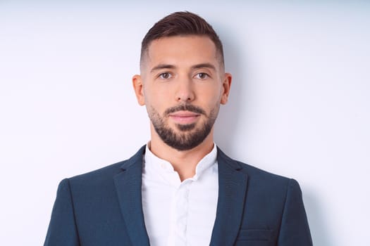 Young handsome man in suit isolated on a white background. Businessman isolated, office people. High quality photo