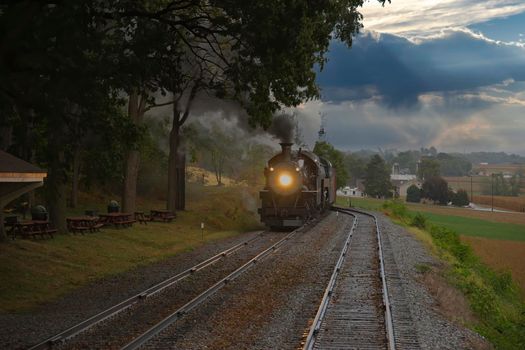 An Antique Restored Steam Freight Train Approaching Head on Blowing Smoke and Steam