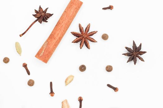 Mulled wine set. A set of spices for mulled wine on a white background. Raisins, ginger, cinnamon, star anise, cardamom, cloves top view on a white background. Hot medicinal drink. Winter cocktail.