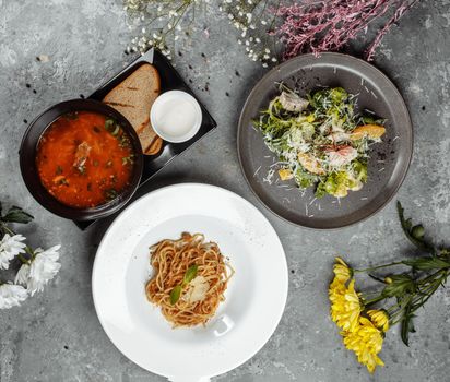 Three-course set menu for a nutritious healthy lunch in a restaurant, Three course set on a table in a business lunch, food set lunch. pasta borsch salad.