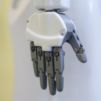 Robot hand on a gray background, close-up. Industrial robotics. Mechanical assistant. Bionic manipulator