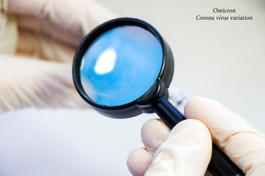 Magnifying glass and human hands with glove, looking and research Omicorn. Corona virus variation