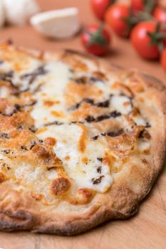 Simple pizza with crunchy crust. Italian pizza. Closeup.