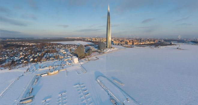 Russia, St. Petersburg, 08 January 2022: Lakhta center skyscraper in a winter frosty evening at sunset, the future main building of the office of the oil company Gazprom, buildings of pink color