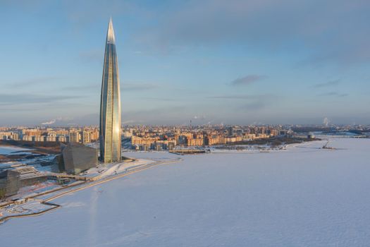 Russia, St. Petersburg, 08 January 2022: Lakhta center skyscraper in a winter frosty evening at sunset, the future main building of the office of the oil company Gazprom, buildings of pink color. High quality photo