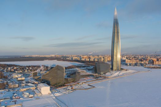 Russia, St. Petersburg, 08 January 2022: Lakhta center skyscraper in a winter frosty evening at sunset, the future main building of the office of the oil company Gazprom, buildings of pink color. High quality photo