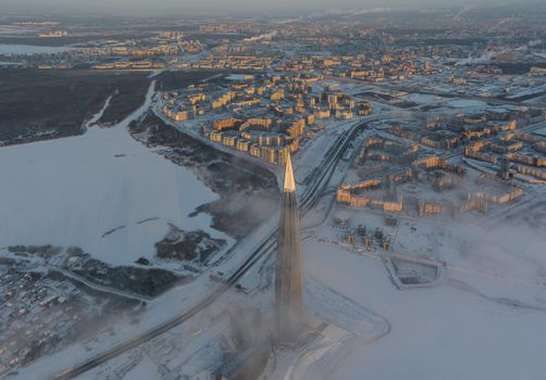 Russia, St. Petersburg, 08 January 2022: Lakhta center skyscraper in a winter frosty evening at sunset, the future main building of the office of the oil company Gazprom, buildings of pink color. High quality photo