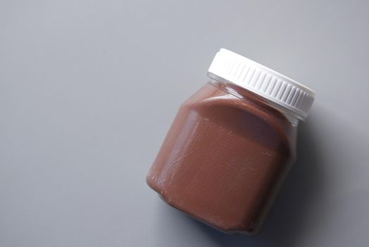Chocolate Hazelnut cream in a container on table .