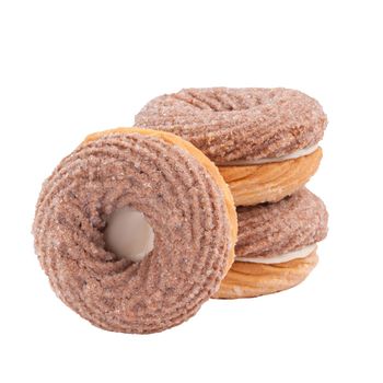 Delicious creamy chocolate shortbread sandwich cookies in shape of ring with milk filling sprinkled with sugar isolated on white background