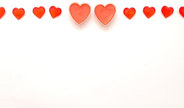 Valentine day background.Two big romantic valentine hearts and several hearts on top on white background.