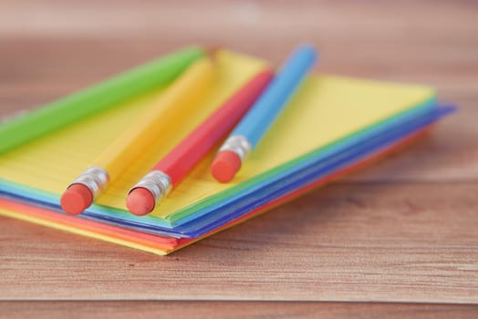 Close up of colorful pencils on notepad .