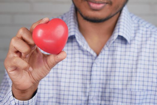 men holding red heart , selective focus .