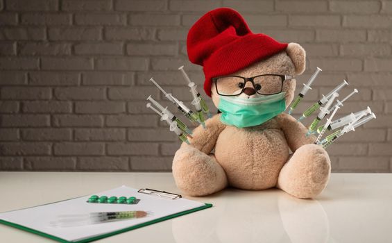 the children's vaccination against the covid19 virus and vaccinations on the example of a teddy bear