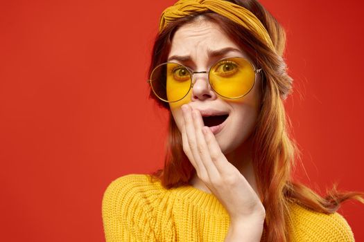 emotional woman wearing yellow glasses fashion studio posing decoration. High quality photo