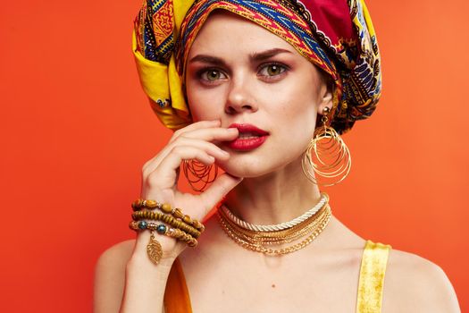 beautiful woman in multicolored turban attractive look Jewelry isolated background. High quality photo