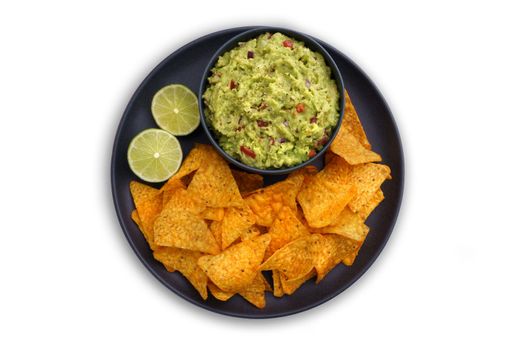 Top view of guacamole dip in black plate with tortilla chips or nachos isolated on a white background. High quality photo