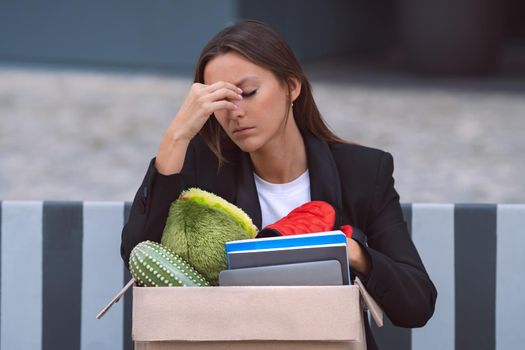 Upset woman got fired from an office job. Dismissal from work or job loss. High quality photo