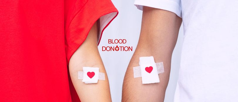 Blood donors with bandage after giving blood. Blood donation, save lives. World blood donor day concept. High quality photo